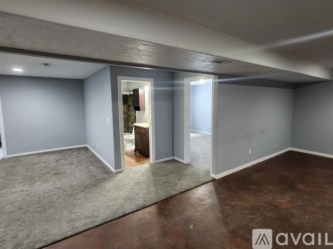 A room with grey walls and a carpeted floor.