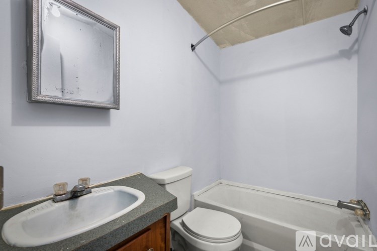 A bathroom with a sink, toilet and bathtub.