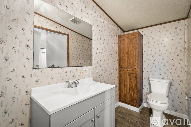 A bathroom with a white sink and a wooden door.