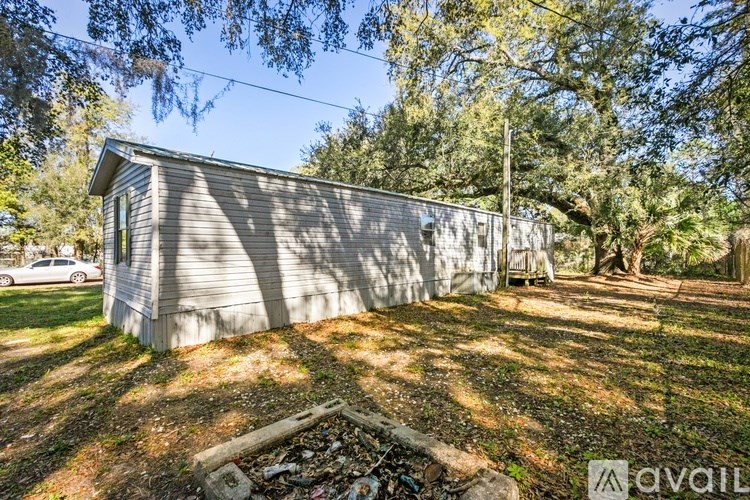 A small house with a car parked in front of it.
