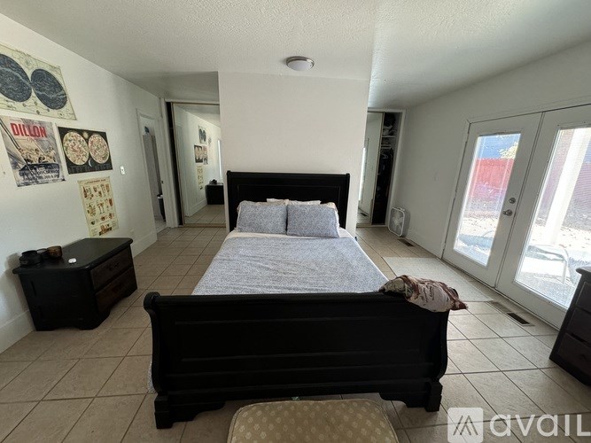 A bedroom with a large bed and a dresser.
