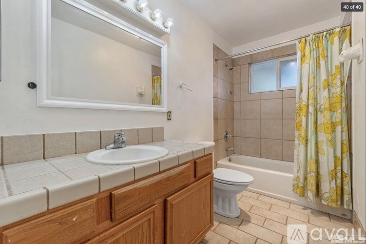 A bathroom with a sink, toilet, and bathtub.