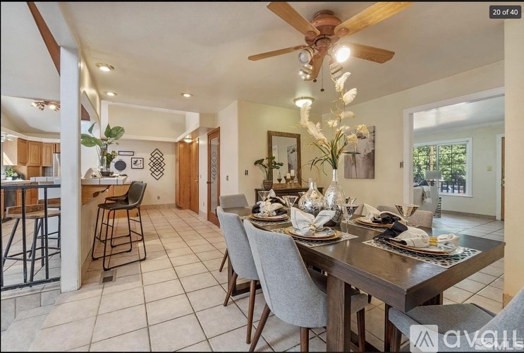A dining room with a table set for six people.