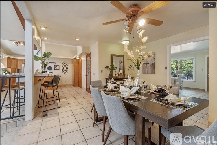 A dining room with a table set for six people.