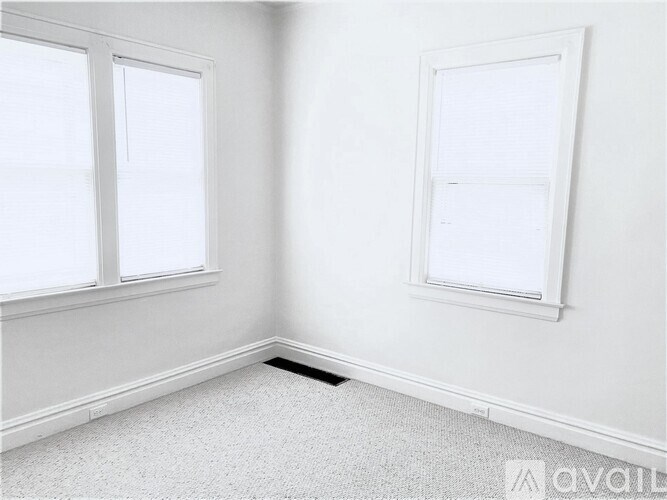 A white room with a window and a door.