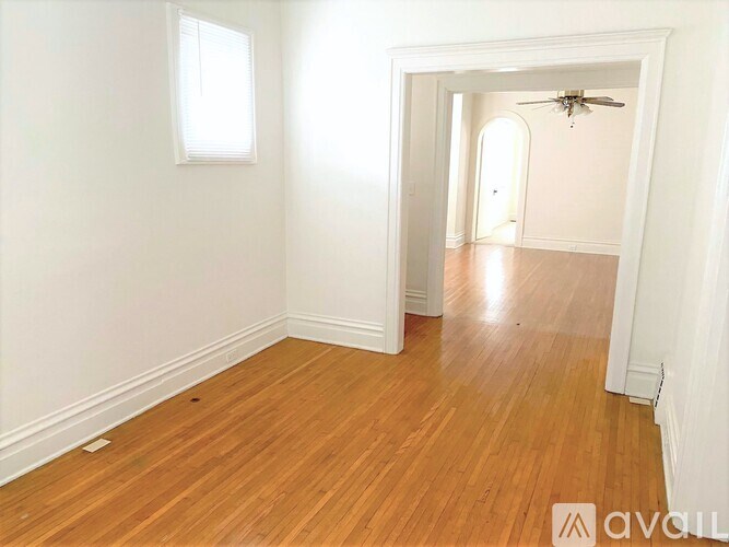 A room with wooden floors and white walls.
