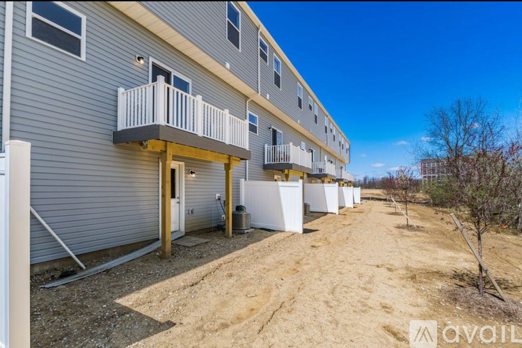 A row of houses with balconies and doors are available for rent.