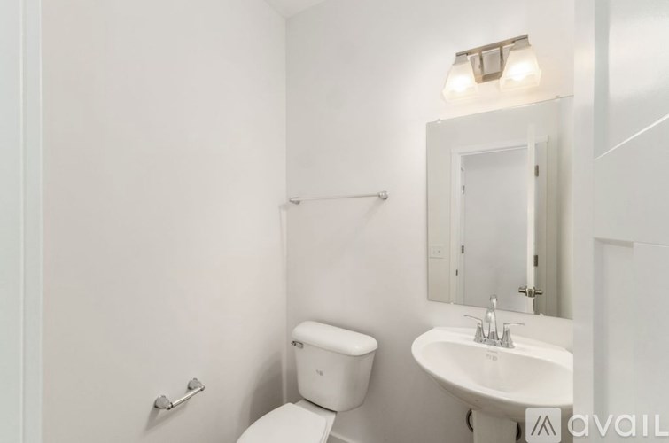 A modern kitchen with a dining area and a living room.