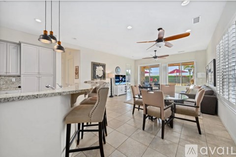 A modern kitchen with a bar area and a dining table set up.