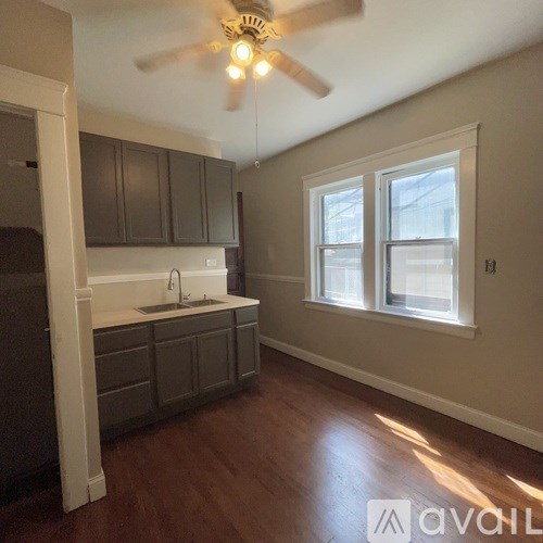A kitchen with a white fridge and a window.