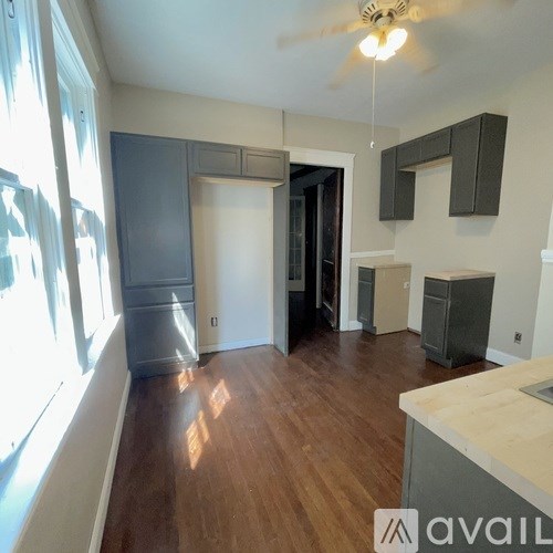 A room with wooden floors and a ceiling fan.