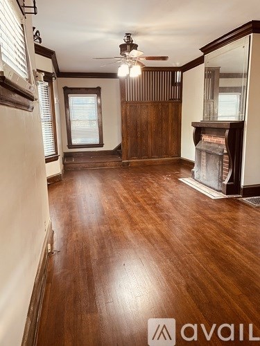 A room with wooden floors and a fireplace.