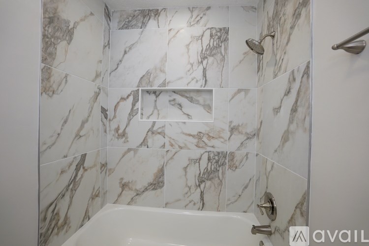 A bathroom with marble tiles on the walls.