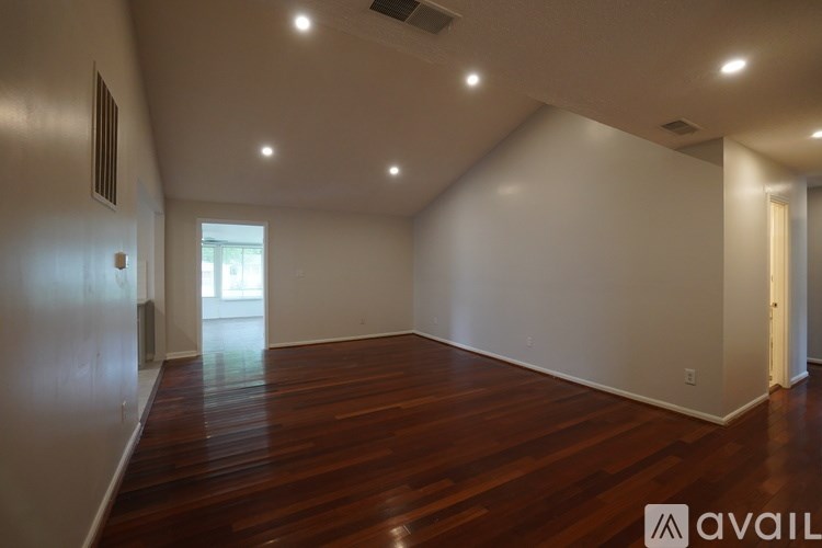 A room with wooden floors and white walls.