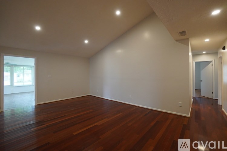 A room with wooden floors and white walls.