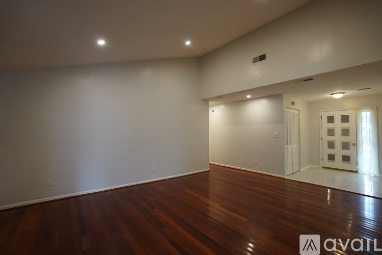 A room with wooden floors and white walls.