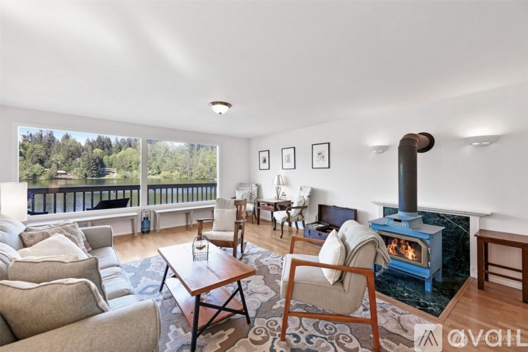 A living room with a wood stove and a couch.