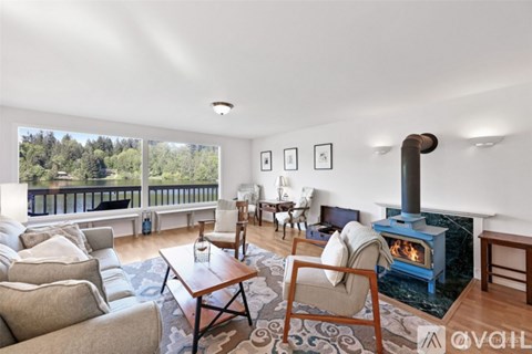 A living room with a wood stove and a couch.