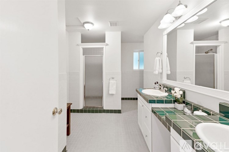 A bathroom with a white sink and a mirror.