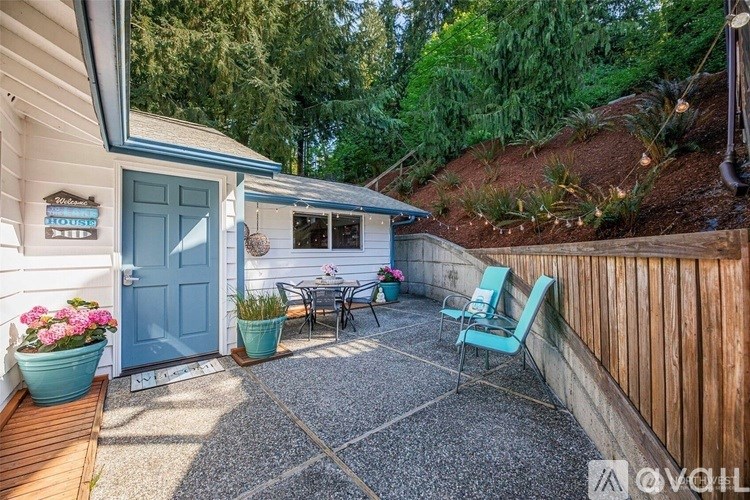 A small backyard with a table and chairs.