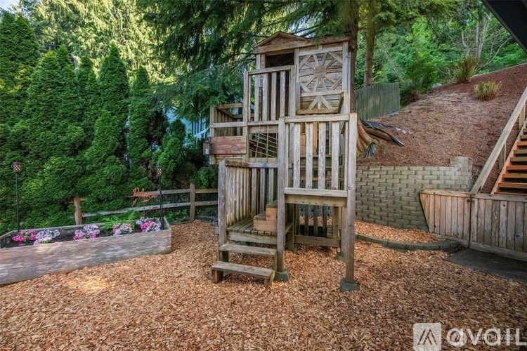 A wooden structure in the middle of a garden.