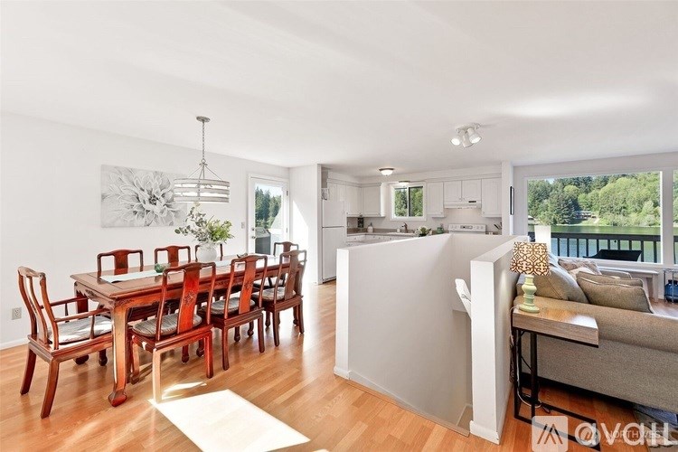 A modern dining room with a wooden table and chairs.