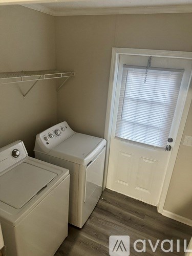 A small laundry room with a washer and dryer.