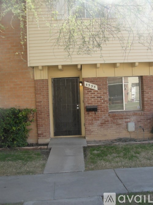 A house with a black door and a number 4595 on the wall.
