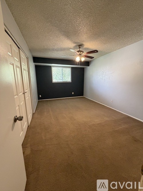 A room with a window and a sign that says "avail".