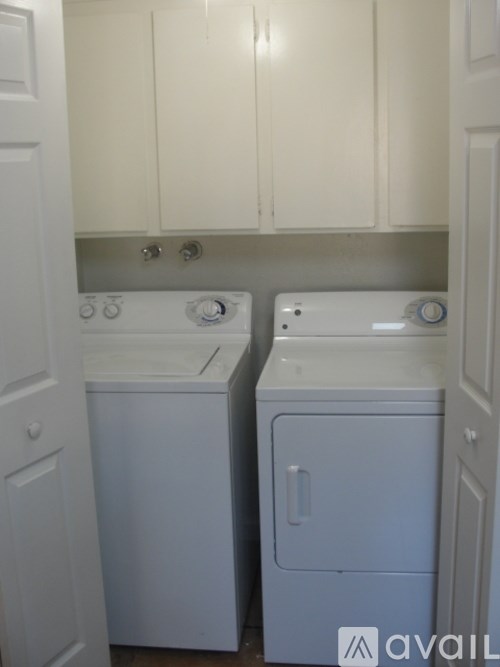 A white washer and dryer in a small laundry room.