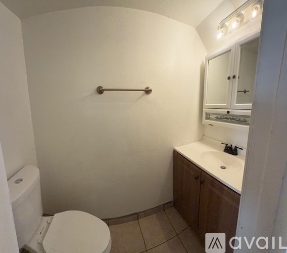 A room with a ceiling fan and a window.