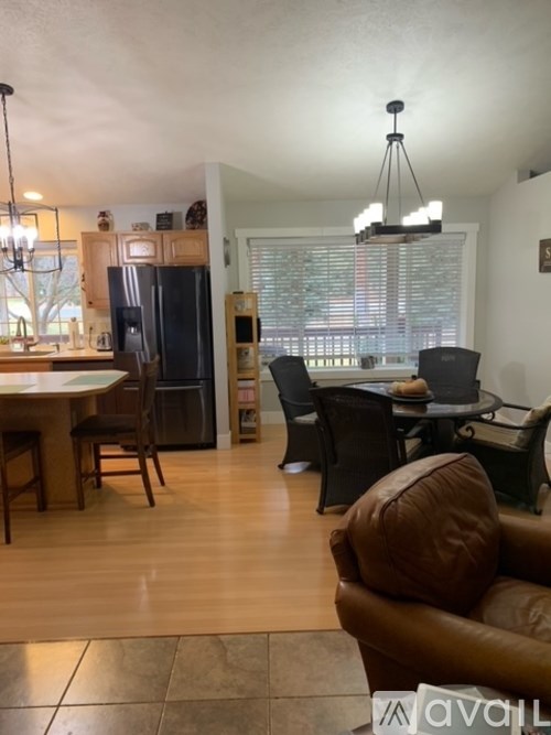 A kitchen with a table and chairs and a couch.