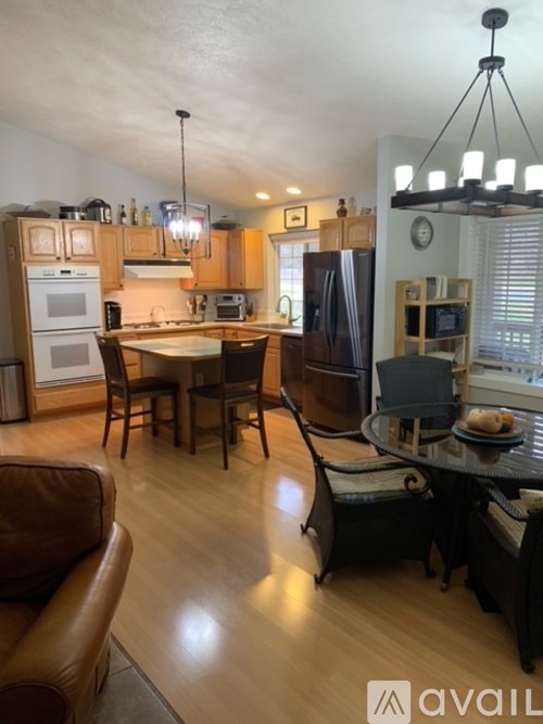A kitchen with a table and chairs in the middle of the room.