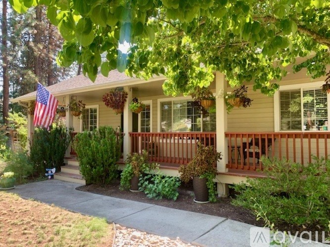 A house with a porch and a flag on the front.