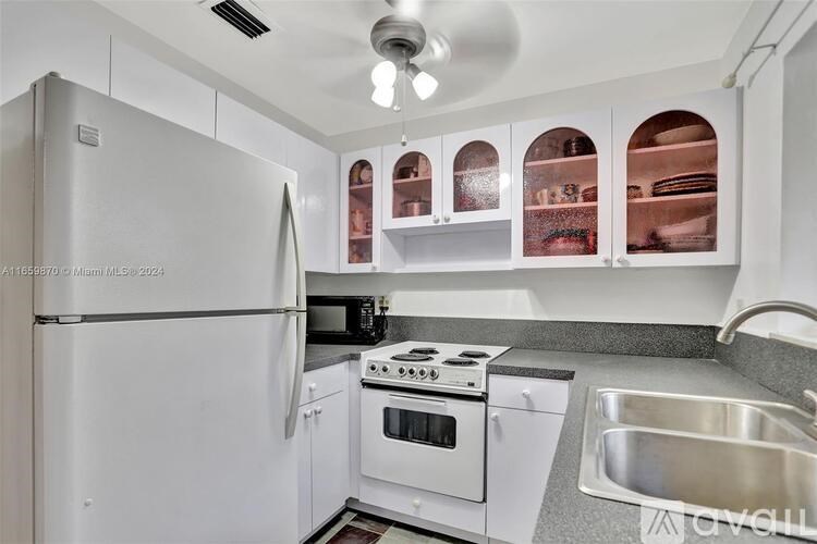 A kitchen with white appliances and a white refrigerator.