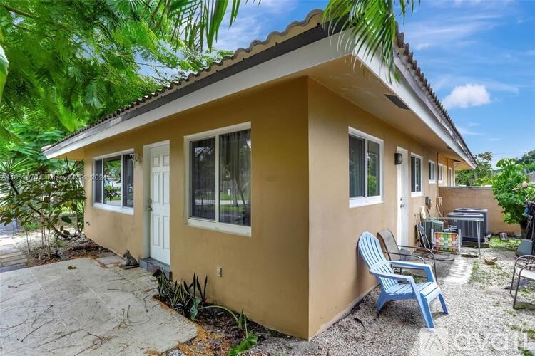 A small house with a patio and a blue chair.