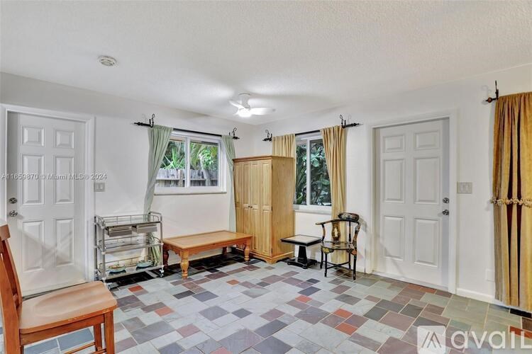A room with a wooden bench and a chair in it.