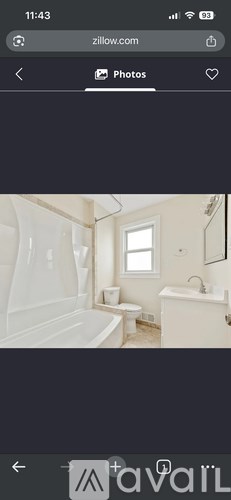 A bathroom with a white tub and toilet.