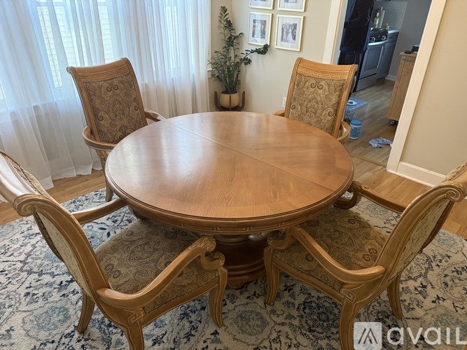 A wooden table surrounded by chairs in a room.
