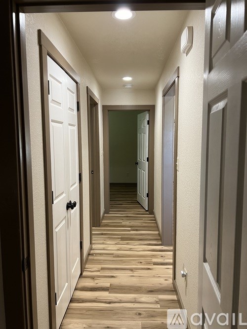 A long hallway with doors on both sides.