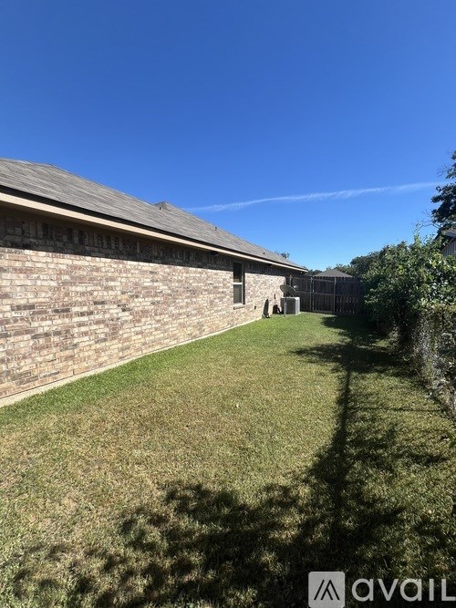 A house with a lawn in front of it.