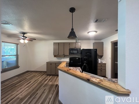 A kitchen area with a counter and a microwave.
