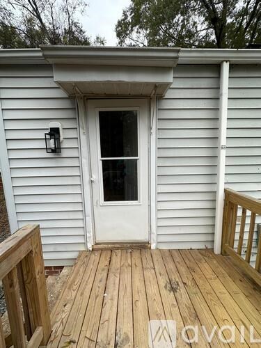 A white door is on a wooden deck.