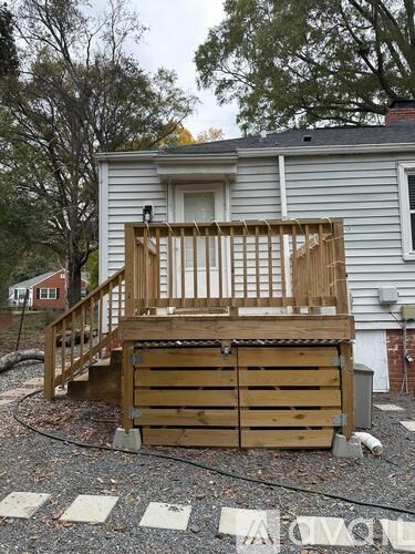 A wooden deck is being constructed in front of a house.