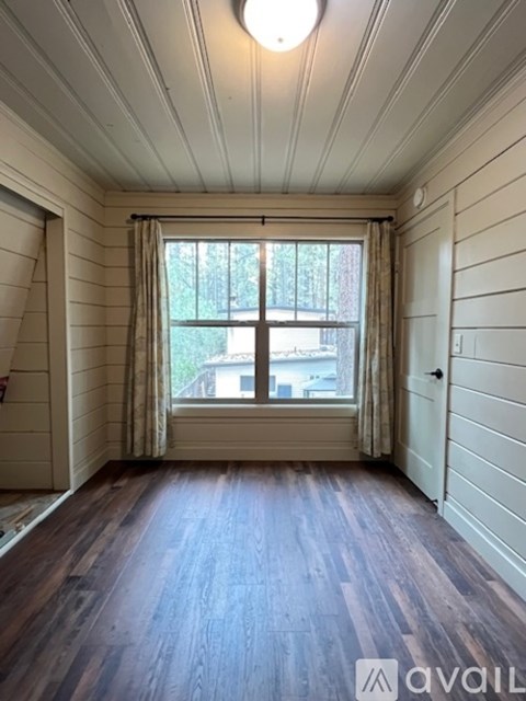 A room with wooden floors and white walls.
