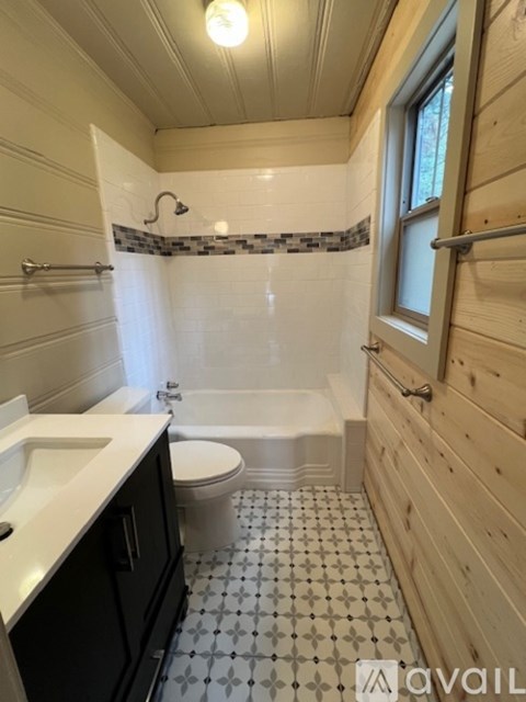 A bathroom with a black and white tiled floor.