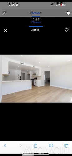A room with wooden flooring and white walls.