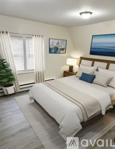 A bedroom with a large bed and a painting on the wall.