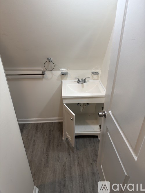 A small white sink in a bathroom.