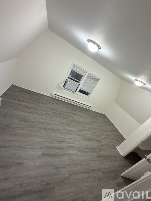 A room with a window and a staircase.